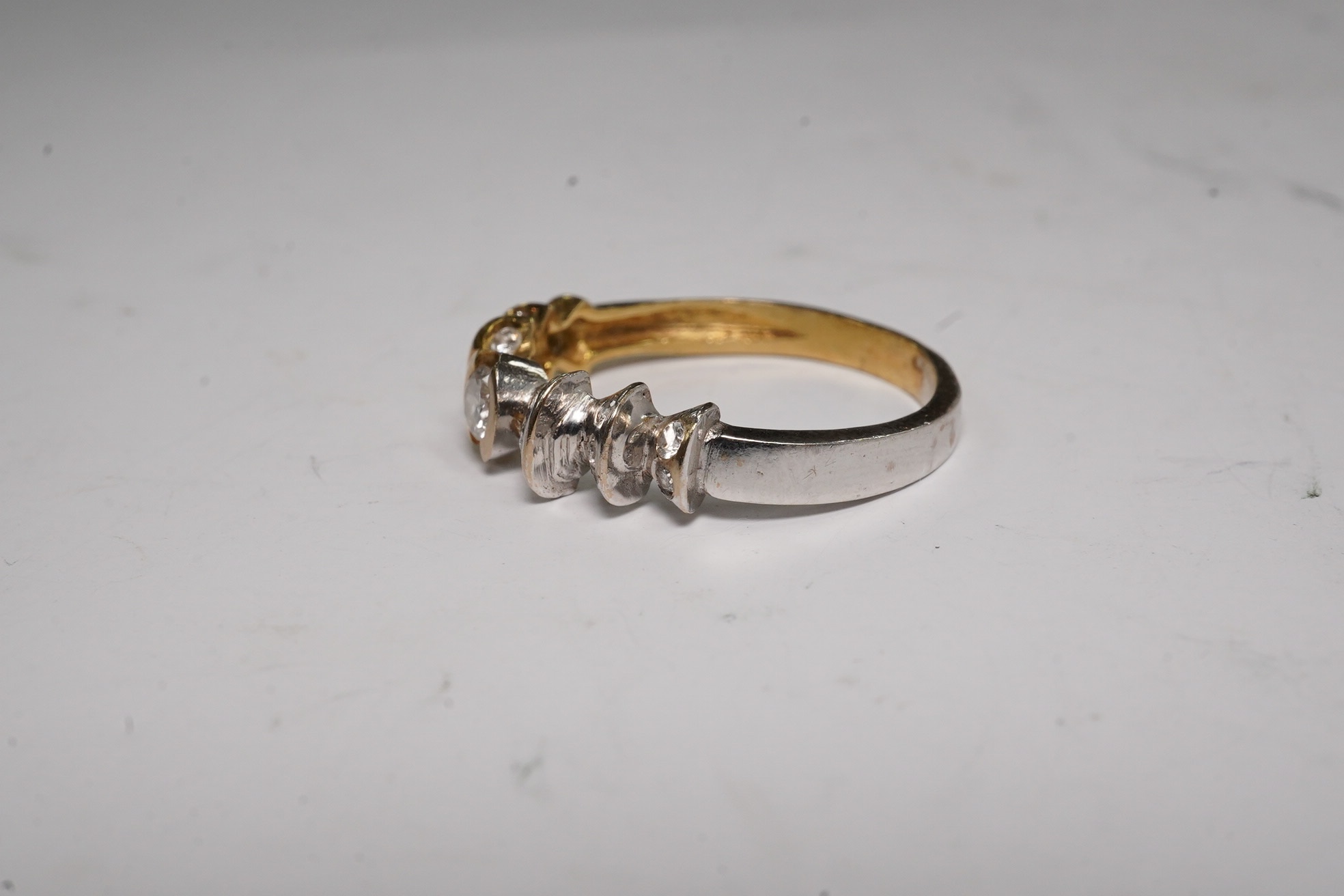 A yellow and white metal and seventeen stone diamond cluster set half hoop ring, size O/P, gross weight 3.3 grams. Condition - fair